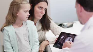 Family Doctor showing Mother and Daughter test results