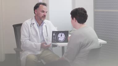 Male Medical Doctor explaining scan results to patient