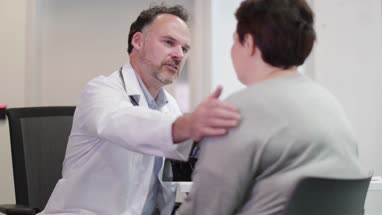 Male Medical Doctor explaining scan results to patient