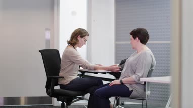 Female Medical Doctor taking an overweight patients blood pressure