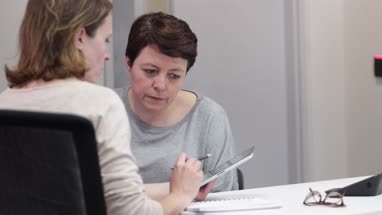 Female Medical Doctor explaining scan results to patient