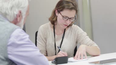 Female Medical Doctor taking a Senior patients blood pressure