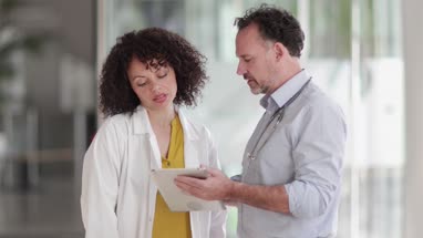 Medical Doctors discussing patient treatment together
