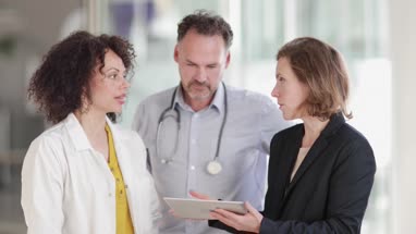 Medical Doctors discussing successful treatment of a patient