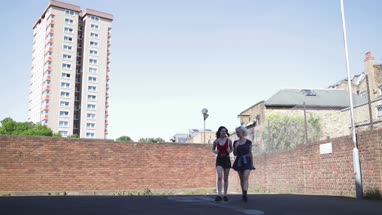 Female friends walking through urban city