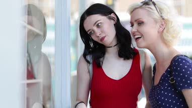 Female friends window shopping in summer
