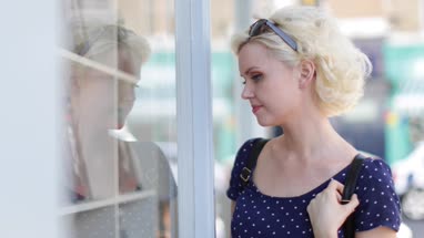 Young adult female window shopping in summer