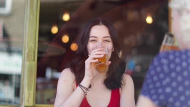 Female friends drinking beer in summer outdoors
