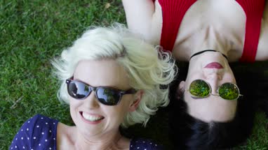 Overhead shot of female friends sunbathing in park