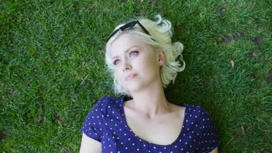 Overhead shot of female sunbathing in park