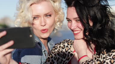 Tourists taking a selfie with Tower Bridge in the background