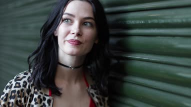 Young adult female waiting for friend on urban street