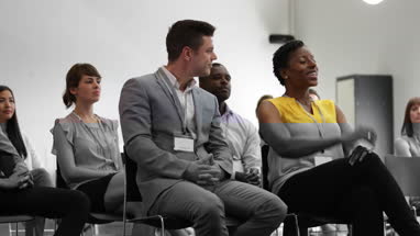 Businesswoman asking a question at a conference