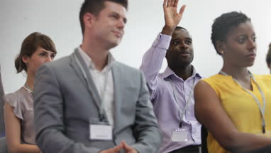 Businessman asking a question at a conference