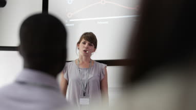 Young female executive speaking at a conference