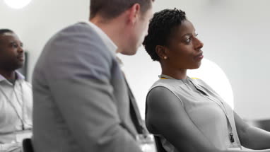 Business colleagues speaking at a conference
