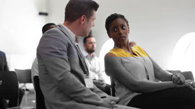 Business colleagues speaking at a conference
