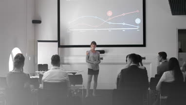 Young female executive speaking at a conference