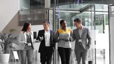 Business team walking through office reception