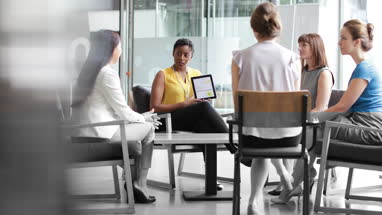 Businesswoman in a meeting using a digital tablet