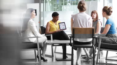 Businesswoman in a meeting using a digital tablet