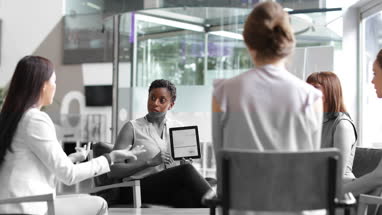 Businesswoman in a meeting using a digital tablet
