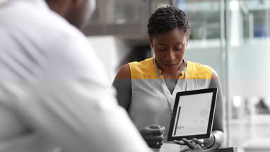 Businesswoman in a meeting using a digital tablet