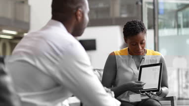 Businesswoman in a meeting using a digital tablet