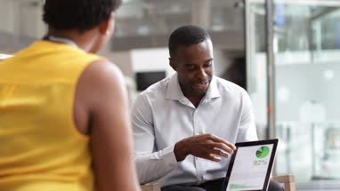 Business meeting in office atrium reception
