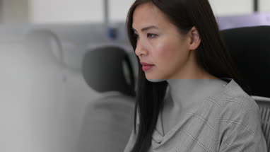 Businesswoman using computer in empty office