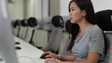 Businesswoman using computer in empty office