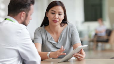 Businesswoman in a meeting using a digital tablet