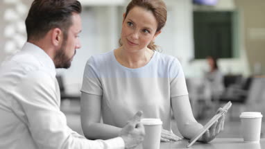 Businesswoman in a meeting using a digital tablet