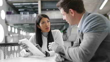 Colleagues in an informal business meeting using a digital tablet