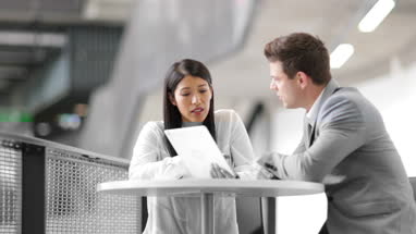 Colleagues in an informal business meeting using a digital tablet