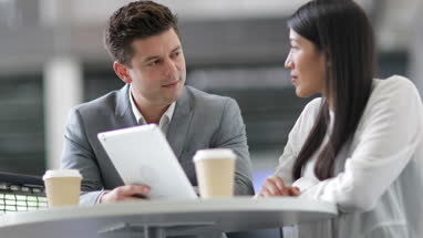Colleagues in an informal business meeting using a digital tablet