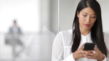 Employees using smartphones in an office