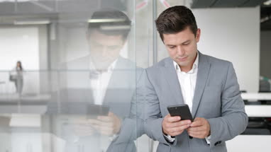 Businessman using smartphone in an office