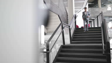 Businessman walking down stairs in an office