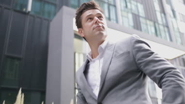 Businessman cycling to a meeting using smartphone
