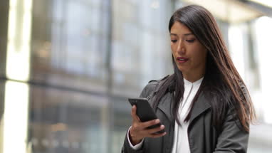 Businesswoman outdoors using smartphone