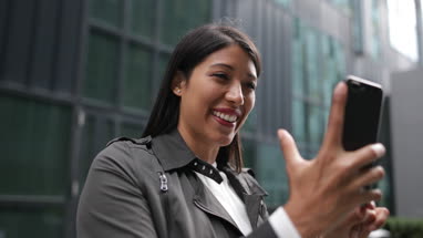 Smiling woman on video call outdoors
