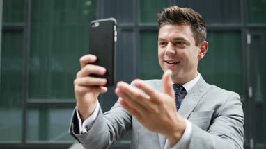 Smiling man on video call outdoors