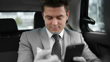 Businessman paying via app for taxi cab ride