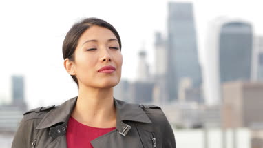 Portrait of businesswoman with London city skyline