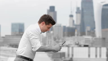Businessman looking out at London city skyline