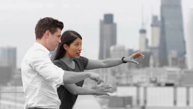 Business colleagues discussing London city skyline