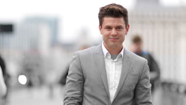 Portrait of businessman on busy street