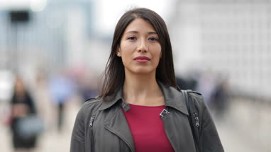 Time lapse of businesswoman on busy street