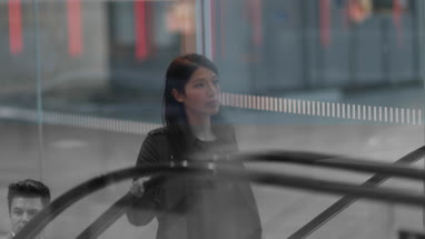 Businesswoman on escalator 